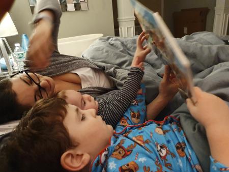 Mark, Mama and Max reading a book the night before Mark's first day in Day Care