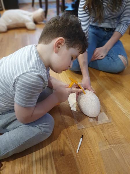 Max excavating dinosaur bones from an egg