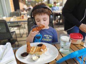 Embodying the spirit of Austin, DJ Max eats Chicken and Waffles for breakfast
