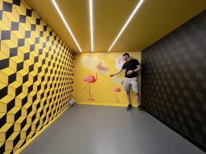 A giant Paul reaches out to a tiny Mark at the Museum of Illusions