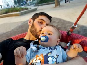 Paul and Mark enjoying a swing in a park in Madrid