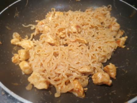 The noodles and chicken with the peanut sauce mixed in